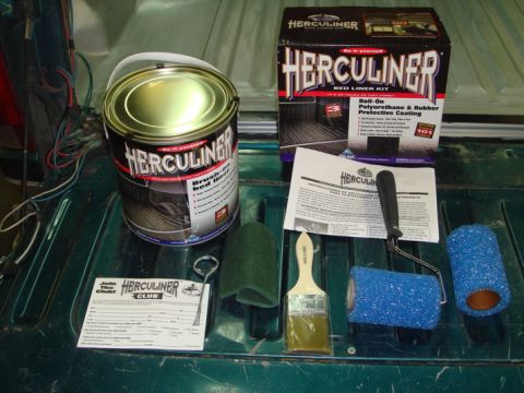 1996 Ford Bronco - A collection of Herculiner products and tools are laid out on a truck bed liner.