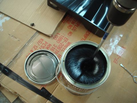1996 Ford Bronco - Mixing Herculiner coating with a drill attachment. The can has readable text and part numbers.