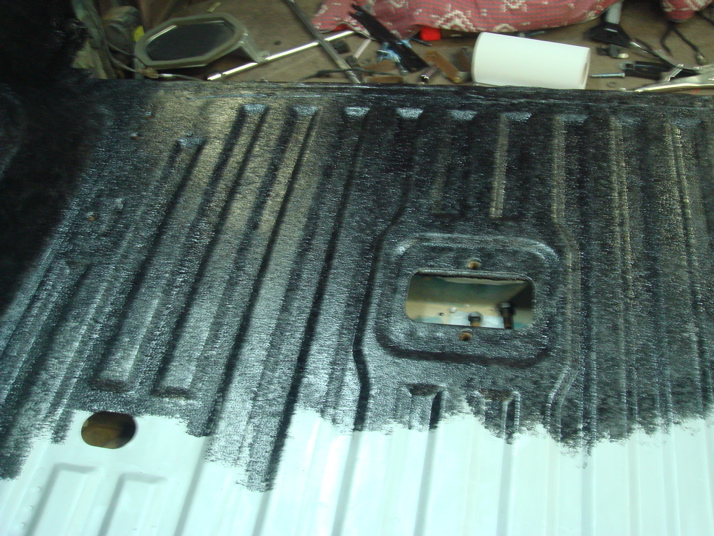Truck bed liner with black textured coating and white painted sections