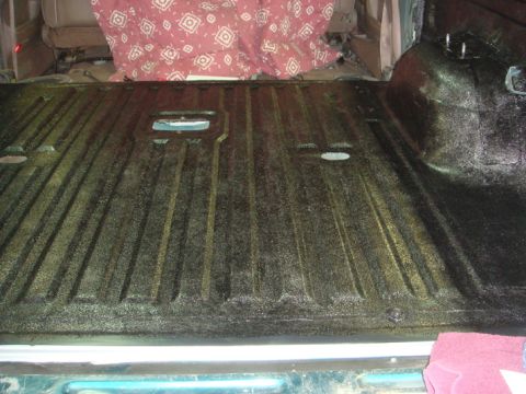 1996 Ford Bronco - Applying bed liner to the cargo area of a vehicle.
