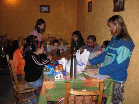 1986 Ford Bronco - A group of people, including children and adults, are gathered around a table indoors.