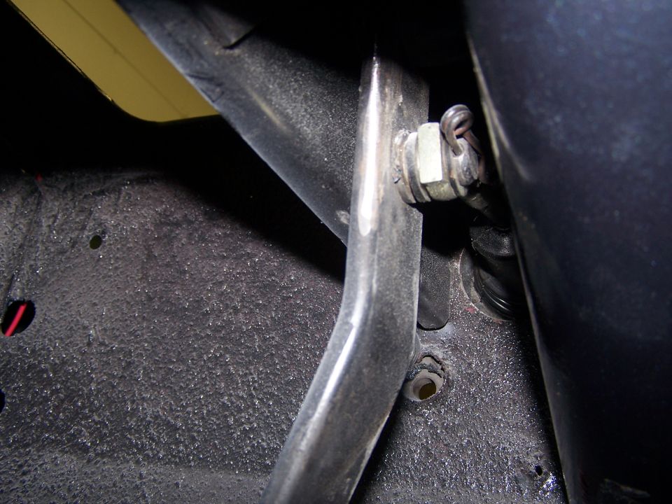 Close-up of a brake line connection with a nut and clip