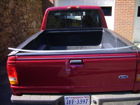 1982 Ford Crown Victoria LTD - Red Ford Ranger pickup truck's rear view, showing the tailgate and bed liner.