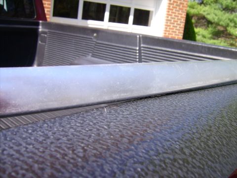 1982 Ford Crown Victoria LTD - Close-up view of a truck bed's interior, showing the textured liner and a metal trim piece.