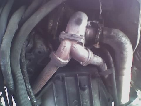 1992 Ford Bronco - This image shows a close-up view of a vehicle's exhaust system and turbocharger components.