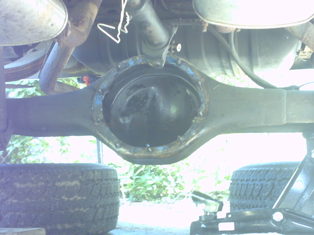 Rear differential assembly with exposed gears, supported by jack stands and tires