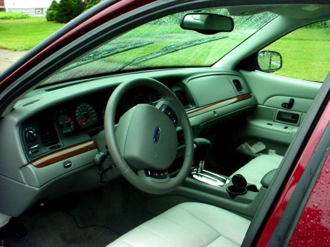 1989 Ford Taurus - Interior view of a red car, showing the dashboard, steering wheel, and seats. Text from Supermotors.net is visible.