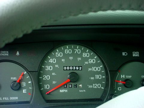 1989 Ford Taurus - Interior view of a car's dashboard, showing the speedometer, odometer, fuel gauge, and temperature gauge.