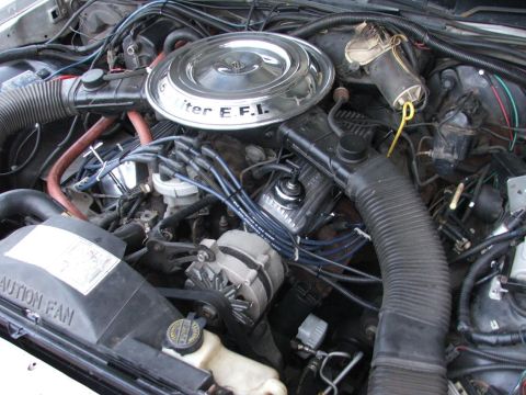 1985 Ford LTD Crown Victoria - Close-up view of a car's engine bay, showing various components and wiring.
