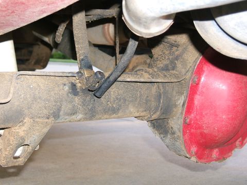1991 Ford Bronco - Close-up view of the rear axle components and exhaust system of a vehicle.