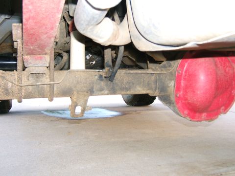 1991 Ford Bronco - Close-up view of a vehicle's rear axle and suspension system, showing the differential and exhaust components.