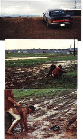 1972 Ford Ranchero - A sedan is parked on a hill overlooking a muddy field where people are interacting with the mud.