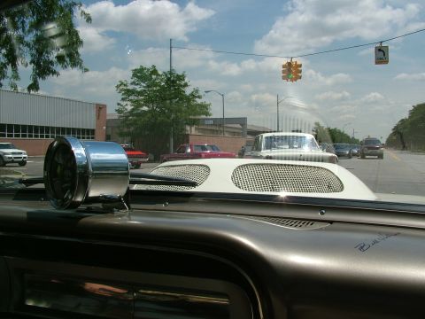 1972 Ford Ranchero - View from inside a car, looking out at traffic. A chrome accessory and hood scoop are prominent in the foreground.