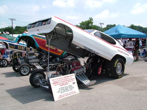 1972 Ford Ranchero - A 1972 Ford Ranchero drag car is displayed with its hood open, revealing its powerful engine and chassis, alongside another dragster.