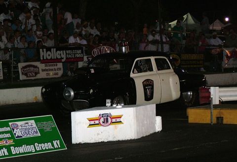 1972 Ford Ranchero - A two-tone police car sits on a drag strip with spectators in the background.