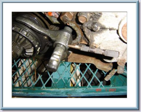 1978 Ford Bronco - Close-up view of a transfer case linkage mechanism, showing gears and mechanical components.