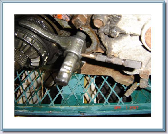 Transfer case linkage mechanism with visible gears and bolts