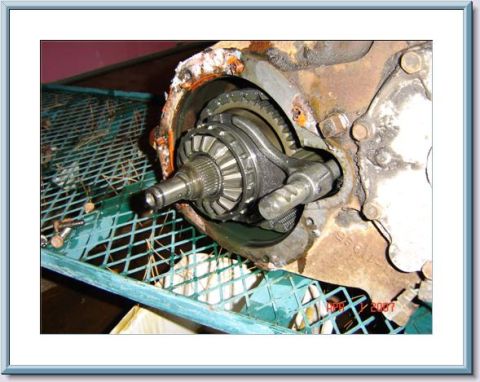 1978 Ford Bronco - Close-up of a worn transfer case component, showing internal gears and a splined shaft.