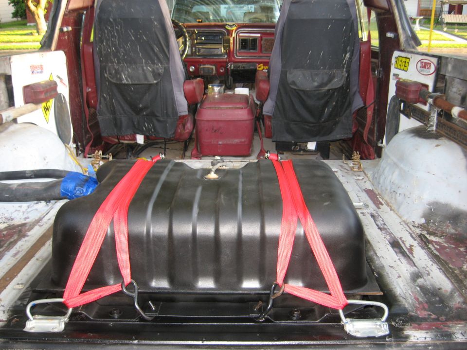 Interior view of a 1979 Ford Bronco with auxiliary fuel tank strapped in cargo area