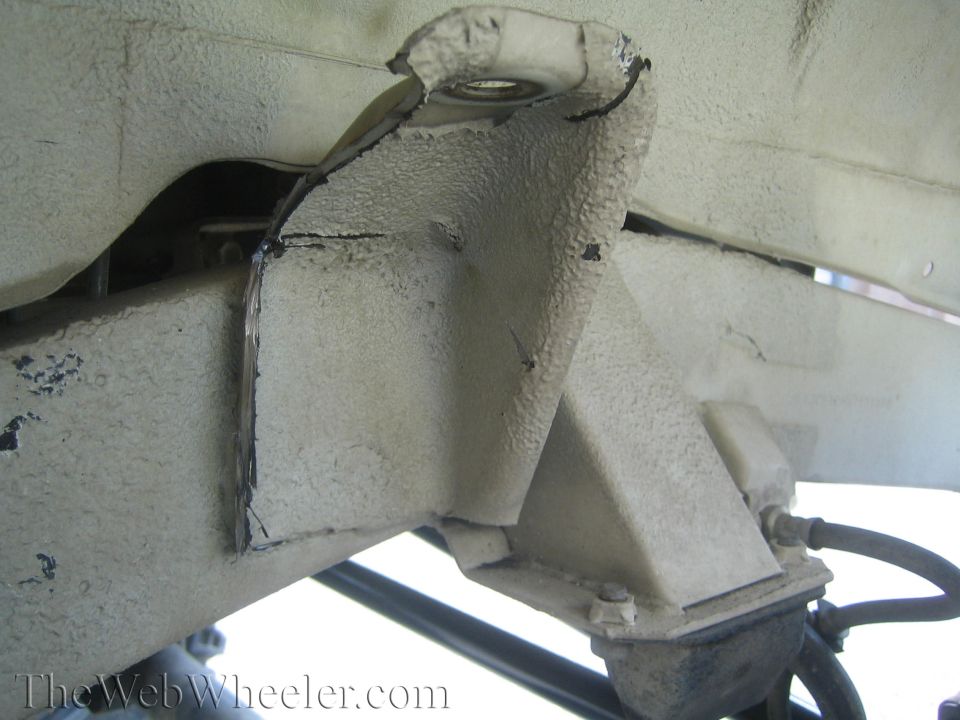 Modified suspension mount on a vehicle frame