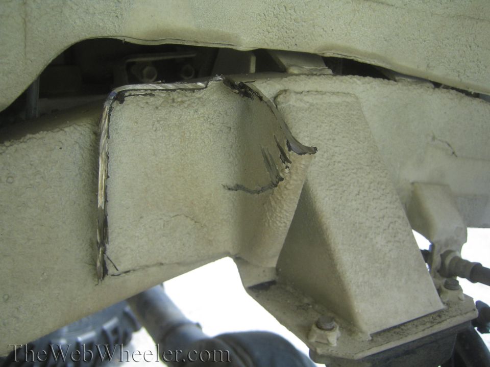 close-up of modified vehicle frame with jagged metal edges