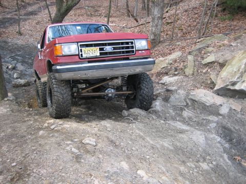 1990 Ford Bronco - This 1990 Ford Bronco is shown tackling a challenging off-road course with its modified suspension.