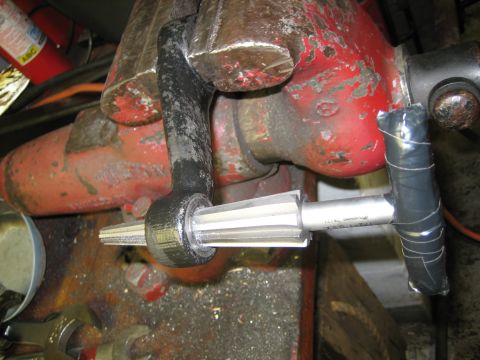 1990 Ford Bronco - A reamer tool is inserted into a steering linkage component secured in a vise.