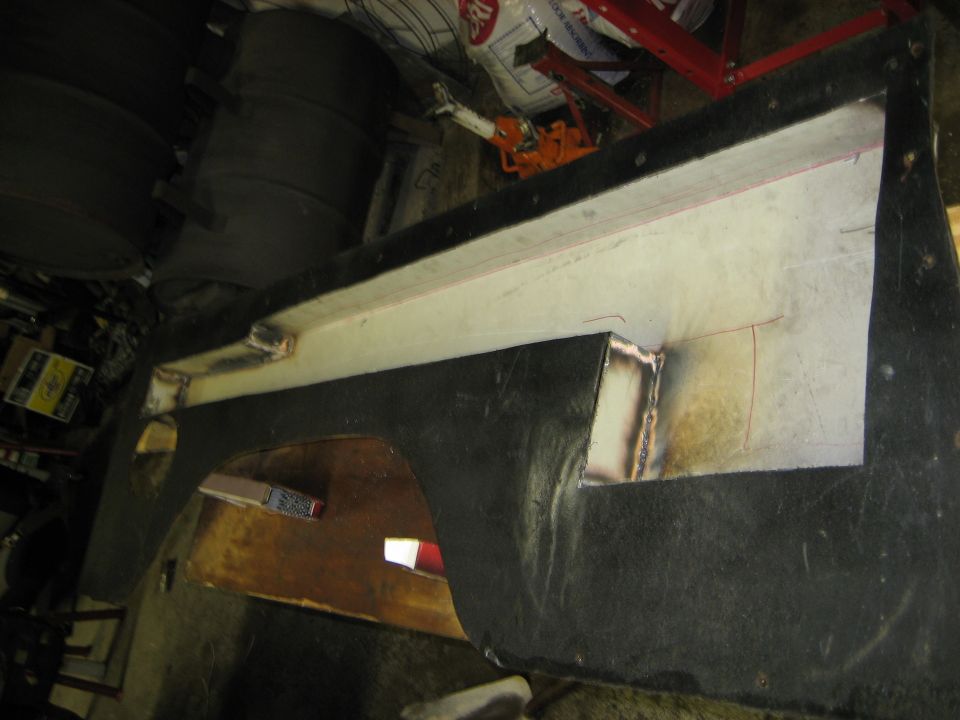 Black car fender with white interior, showing welded metal reinforcement