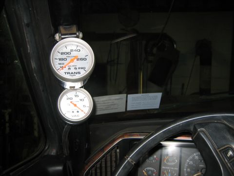 1990 Ford Bronco - Transmission temperature and vacuum gauges mounted inside the vehicle's cabin.