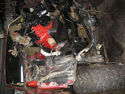 1990 Ford Bronco - The engine bay shows a red engine block with extensive wiring and components visible.
