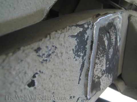1987 Suzuki Samurai - A close-up view of a welded metal frame section, showing signs of wear and chipped paint.
