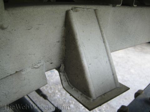 1987 Suzuki Samurai - Detail of a welded bracket on a vehicle's chassis, likely part of suspension or frame reinforcement.