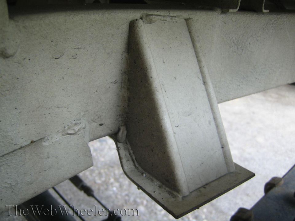 Close-up of a welded metal bracket on a vehicle frame