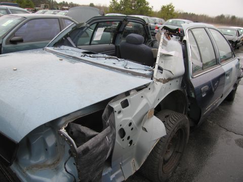 1991 Ford LTD Crown Victoria - This 1991 Ford Crown Victoria LTD is heavily damaged and appears to be in a junkyard.