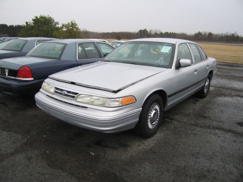 1991 Ford LTD Crown Victoria - A silver 1991 Ford Crown Victoria LTD is parked in an outdoor lot with its hood ajar.