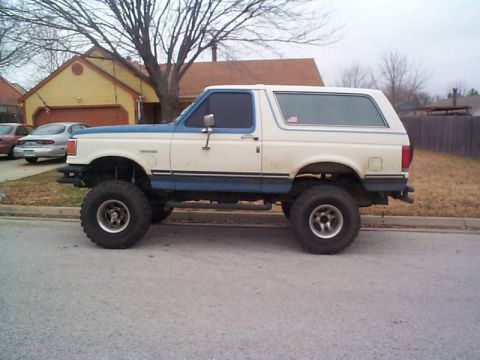 1978 Ford Bronco - This lifted Ford Bronco is parked on the side of a residential street.