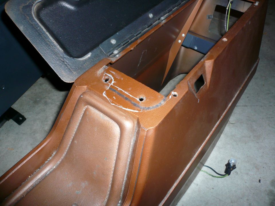 Brown vinyl center console with black lid, showing mounting holes and wiring