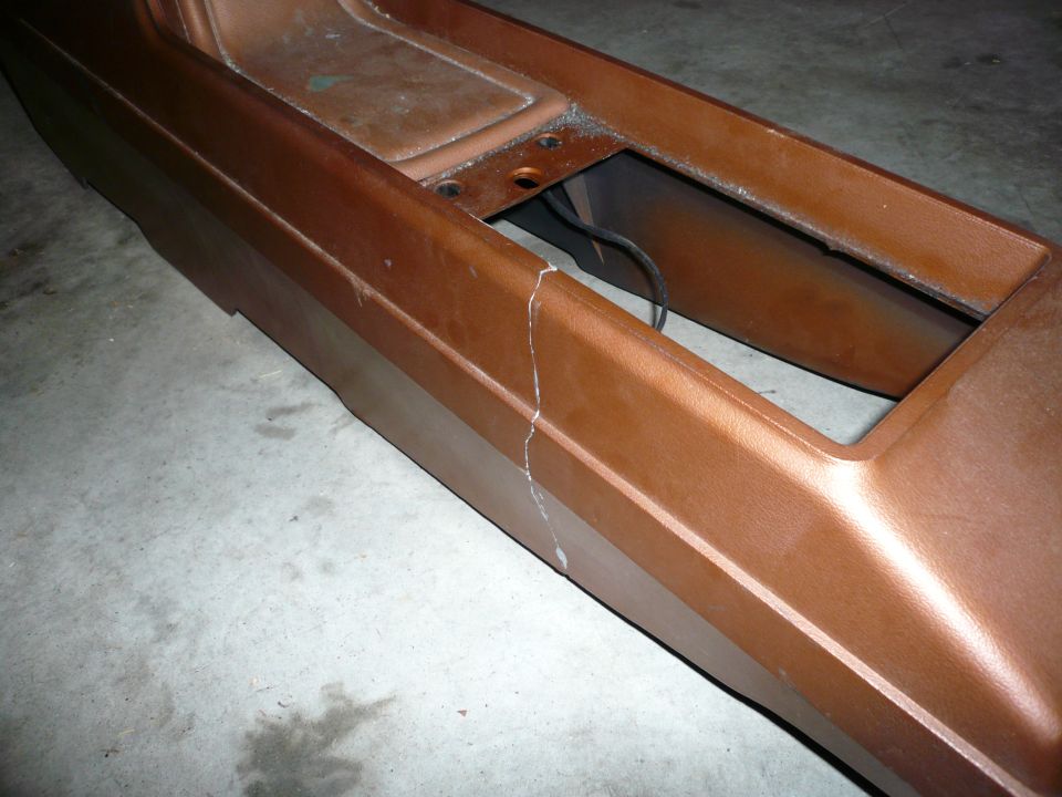 Cracked brown center console part