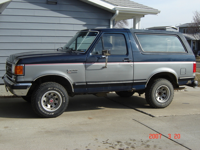 Side view of a 1988 Ford Bronco in blue and silver two-tone paint