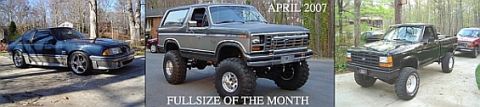 1986 Ford Bronco - A lifted Ford Bronco and a pickup truck are shown in a driveway with trees in the background.