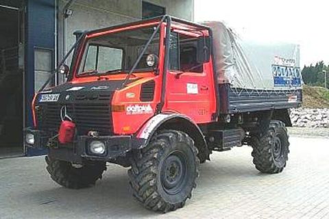1991 Ford Bronco - This Unimog truck has large off-road tires and a roll cage over the cab.