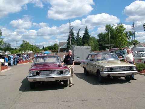 1972 Ford Ranchero - Two classic Ford cars are displayed outdoors with men standing beside them.