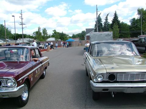 1972 Ford Ranchero - Two classic cars, a gold Ford Falcon and a maroon Ford Ranchero, are parked side-by-side on a street.