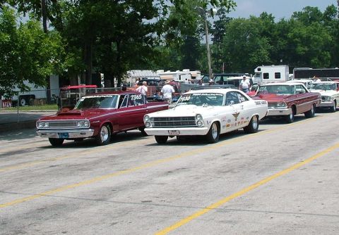 1972 Ford Ranchero - A line of drag racing cars, including a white 1966 Ford Fairlane, are staged on a track.