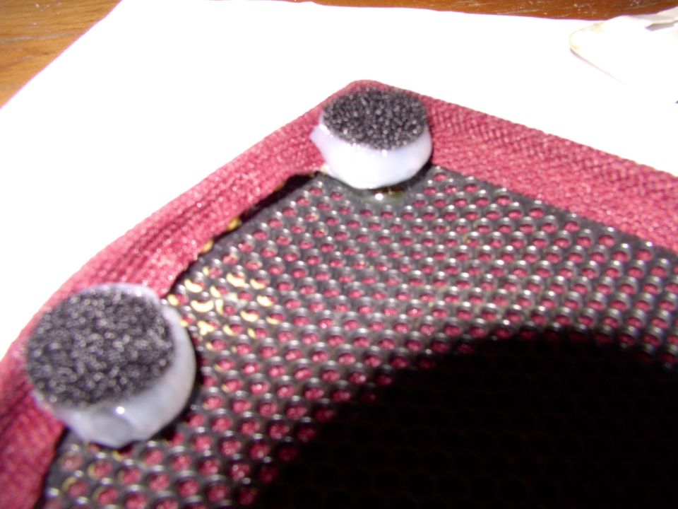 Just a huge dab of plain silicone to grab hold onto the speaker cover. It will also make up the missing height needed to put the velcro patch in contact with the one you'll stick on the door panel. I just squash the silicone down to the desired height using the velcro patch.