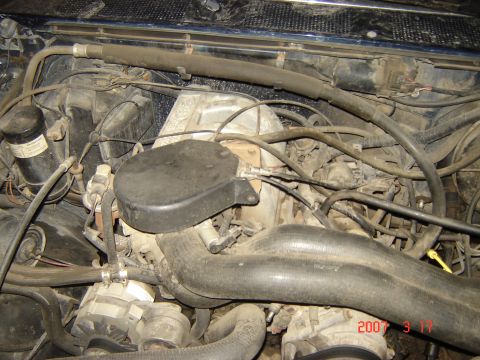1988 Ford Bronco - Close-up view of a vehicle's engine compartment, showing various mechanical parts and wiring.