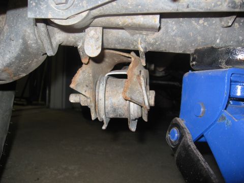 1974 Ford F-100 - A close-up view of a damaged suspension component on a vehicle.