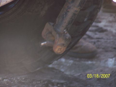 1989 Ford Bronco - A close-up view of a rusty metal component attached to a tire, with a date stamp of 03/18/2007 visible.