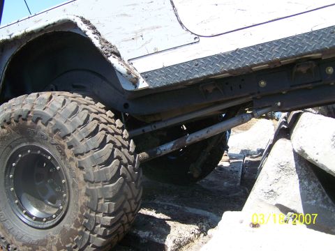 1989 Ford Bronco - This off-road vehicle is shown from the side, with its large tires and suspension system visible as it moves over rocks.