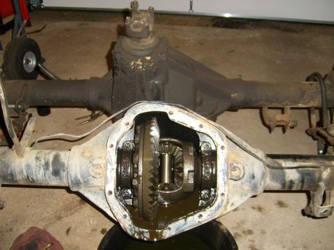 1994 Ford Bronco - The differential housing is open, showing the internal gears and some fluid.